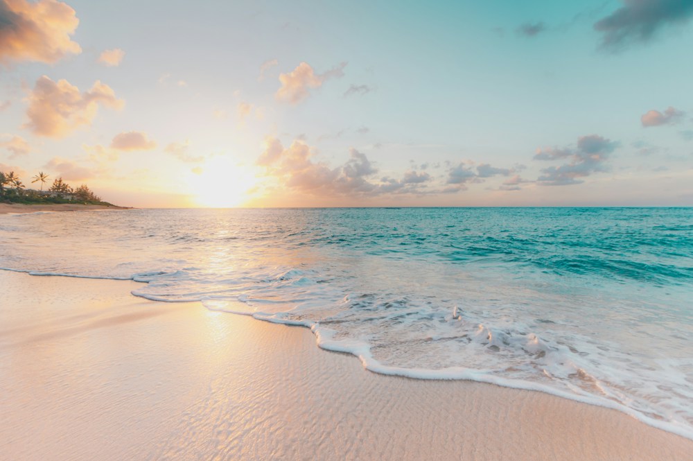 A quiet beach with soft sand and clear blue water